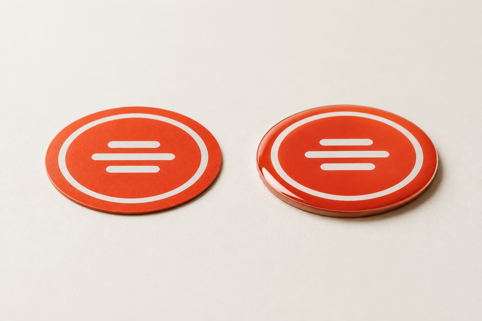 Side-by-side comparison of a flat vinyl sticker and the same logo as a 3D resin domed sticker